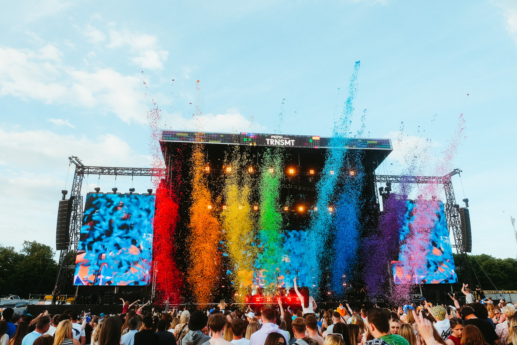 photo of main stage with bright rainbow confetti in the air